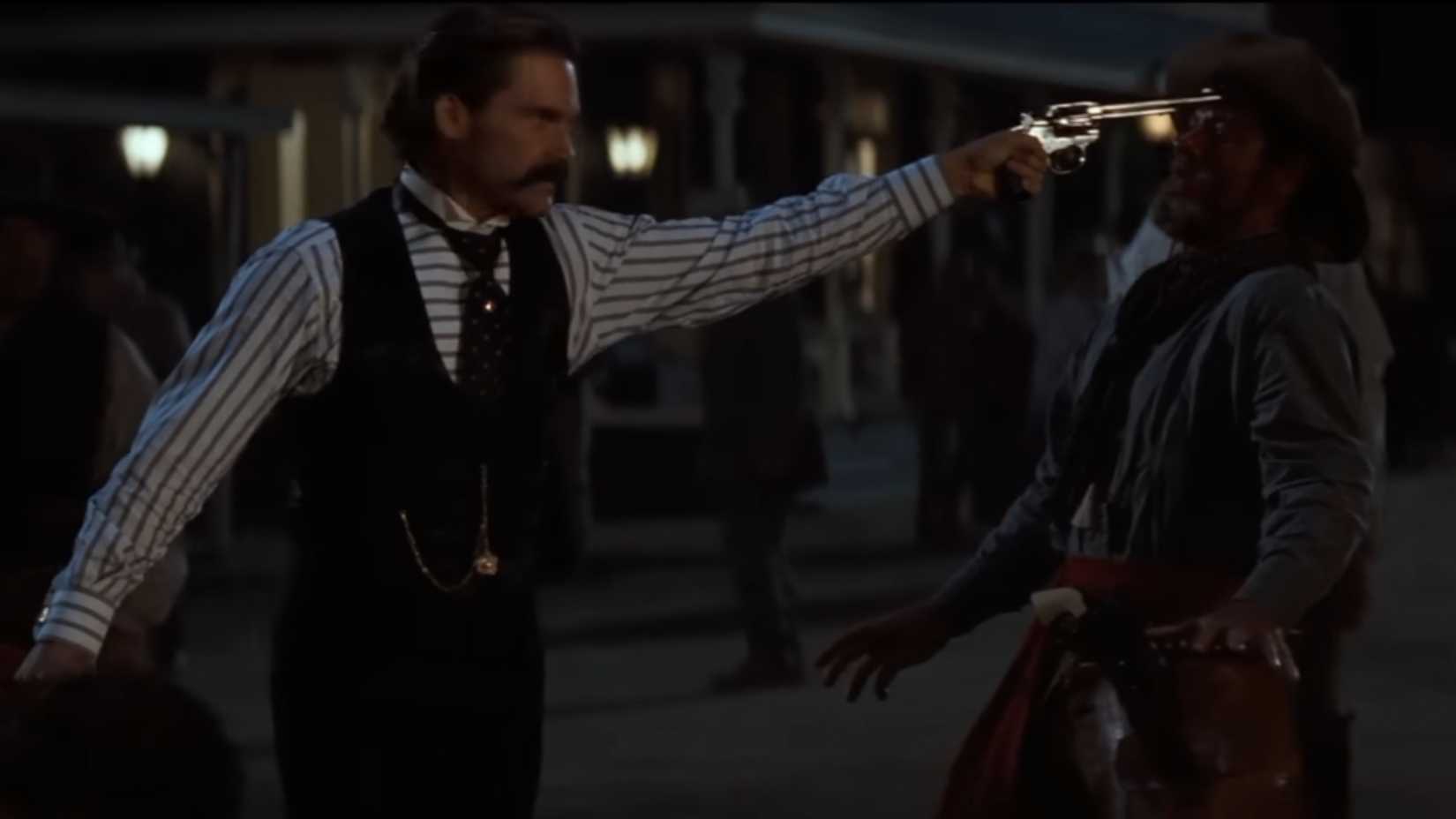 Wyatt Earp holding a cowboy at gunpoint in Tombstone