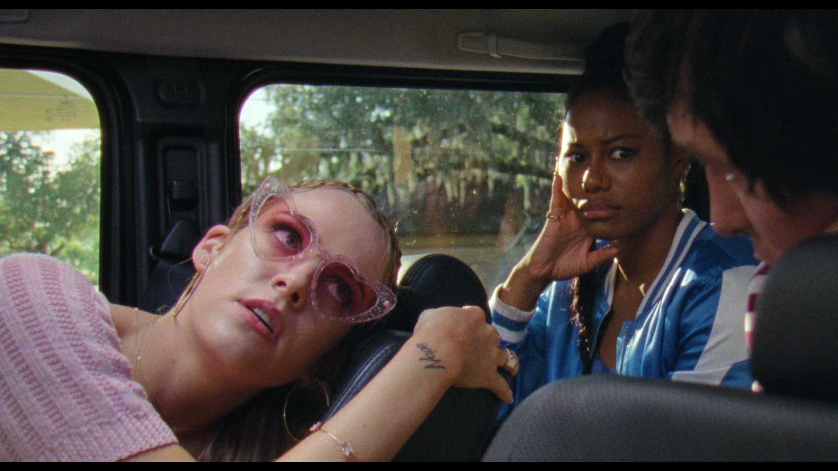 Zola and  Stefani look at Derrek while sitting in a car in Zola (2021)