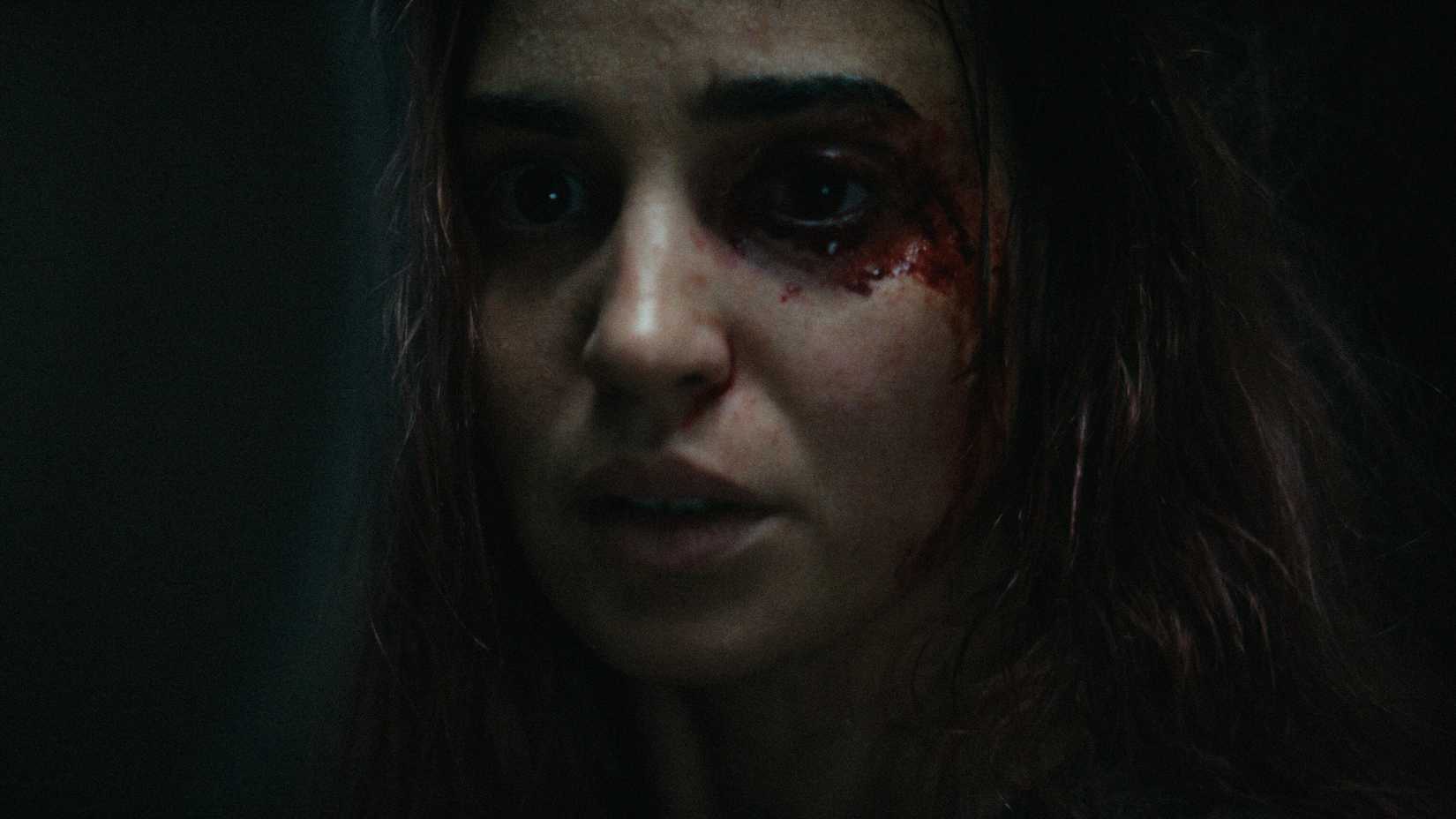 Souheila Yacoub with blood on her face in Evil Dead Burn