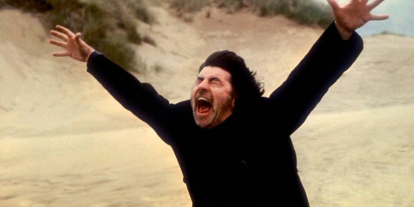 A man shouting with has hands in the air in The Shout (1978)