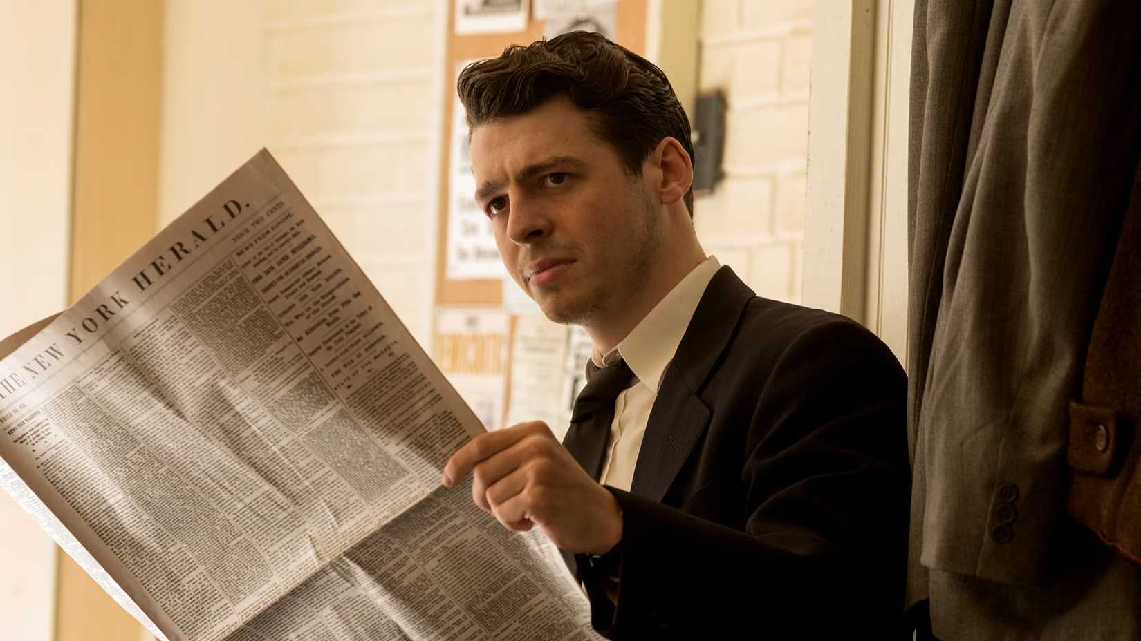 A man sits reading The New York Herald in The Plot Against America