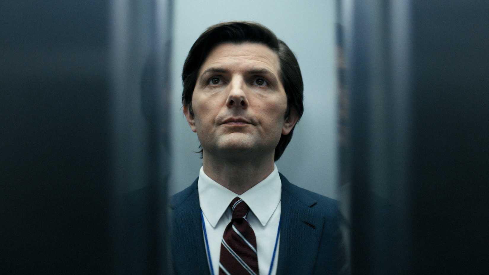 Adam Scott standing in an elevator as the doors are about to close