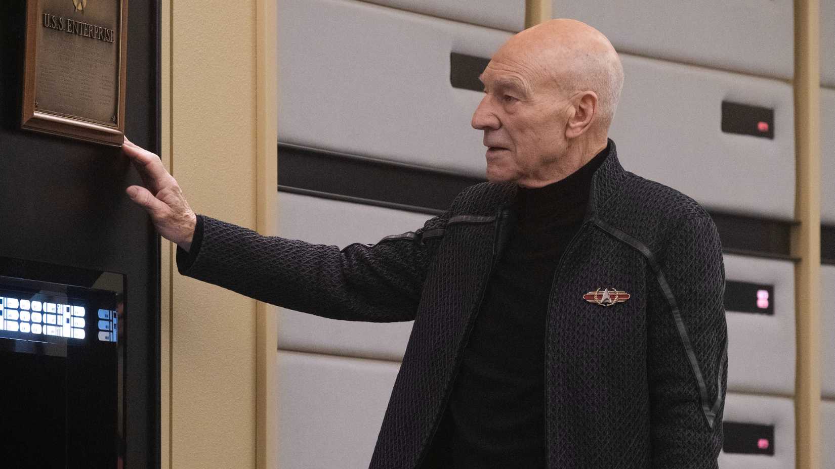 Admiral Picard touches Enterprise plaque