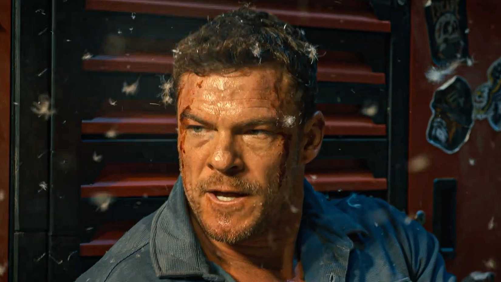 Alan Ritchson's Hank looking mad with feathers floating around him in Runner
