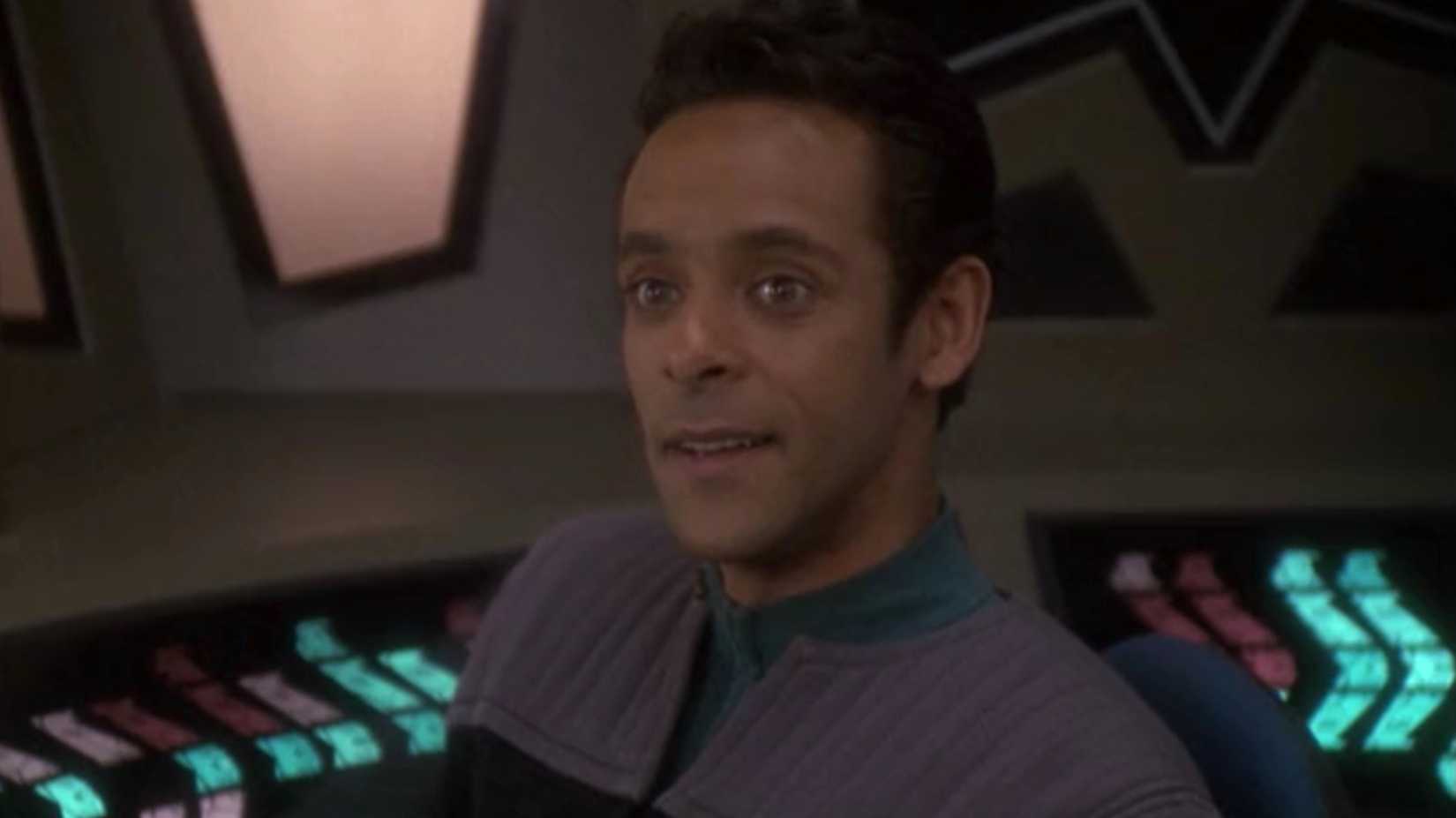 Julian Bashir smiling at seeing Ezri Dax entering his office