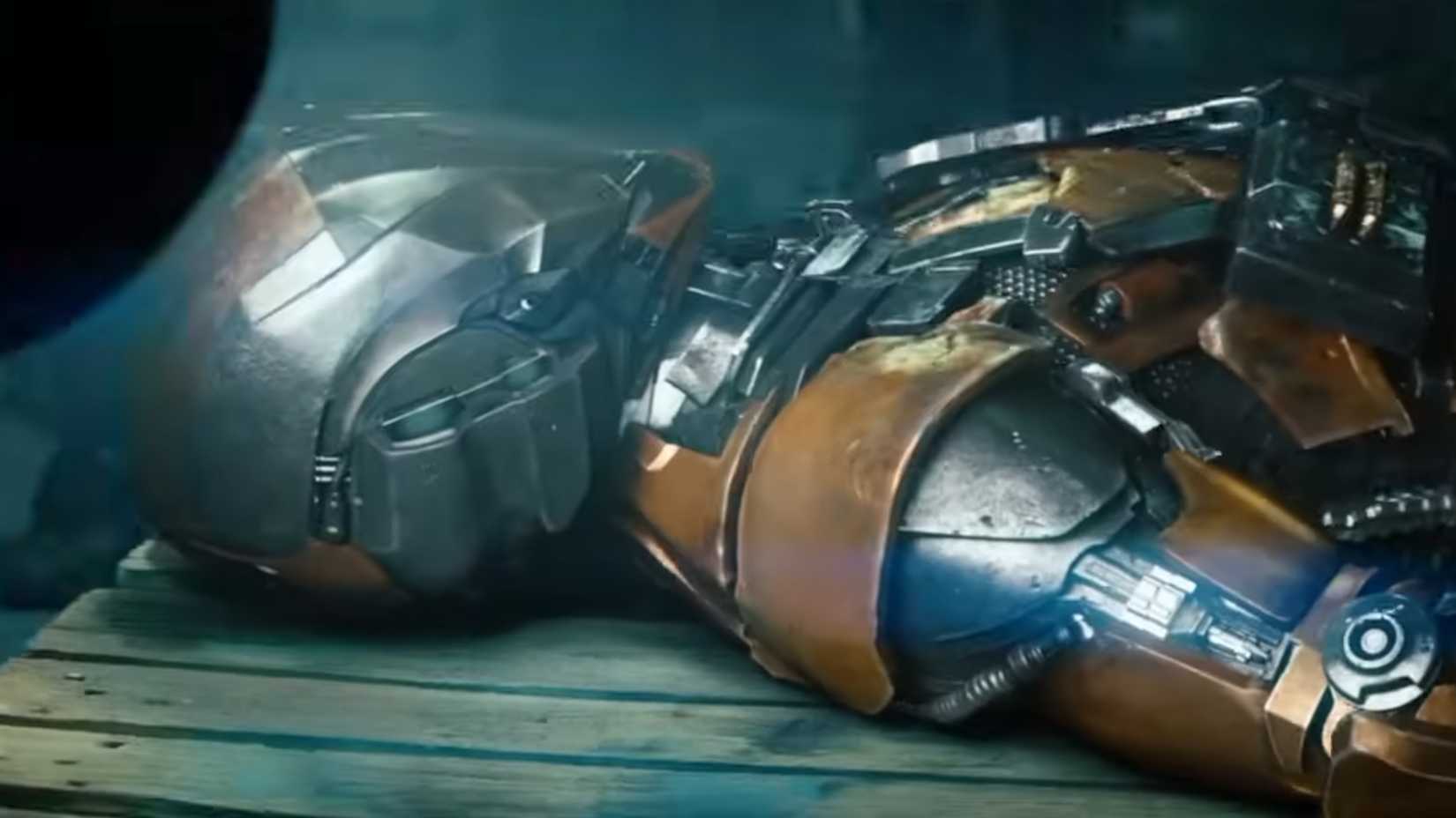 An armored mech suit laying down surrounded by army personell in Battleship