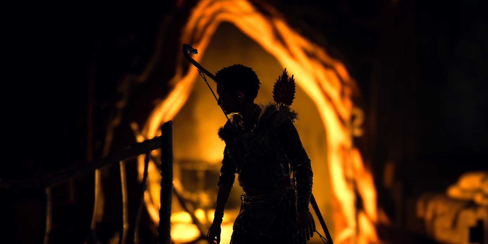 Atreus in front of a fireplace in God of War 2018