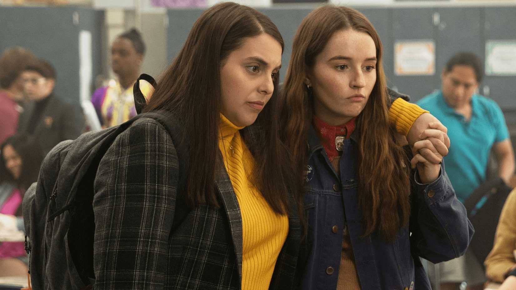 Beanie Feldstein and Kaitlyn Dever stand at school in Booksmart
