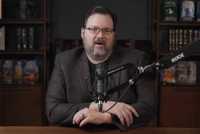 Brandon Sanderson talks into a microphone on his YouTube channel