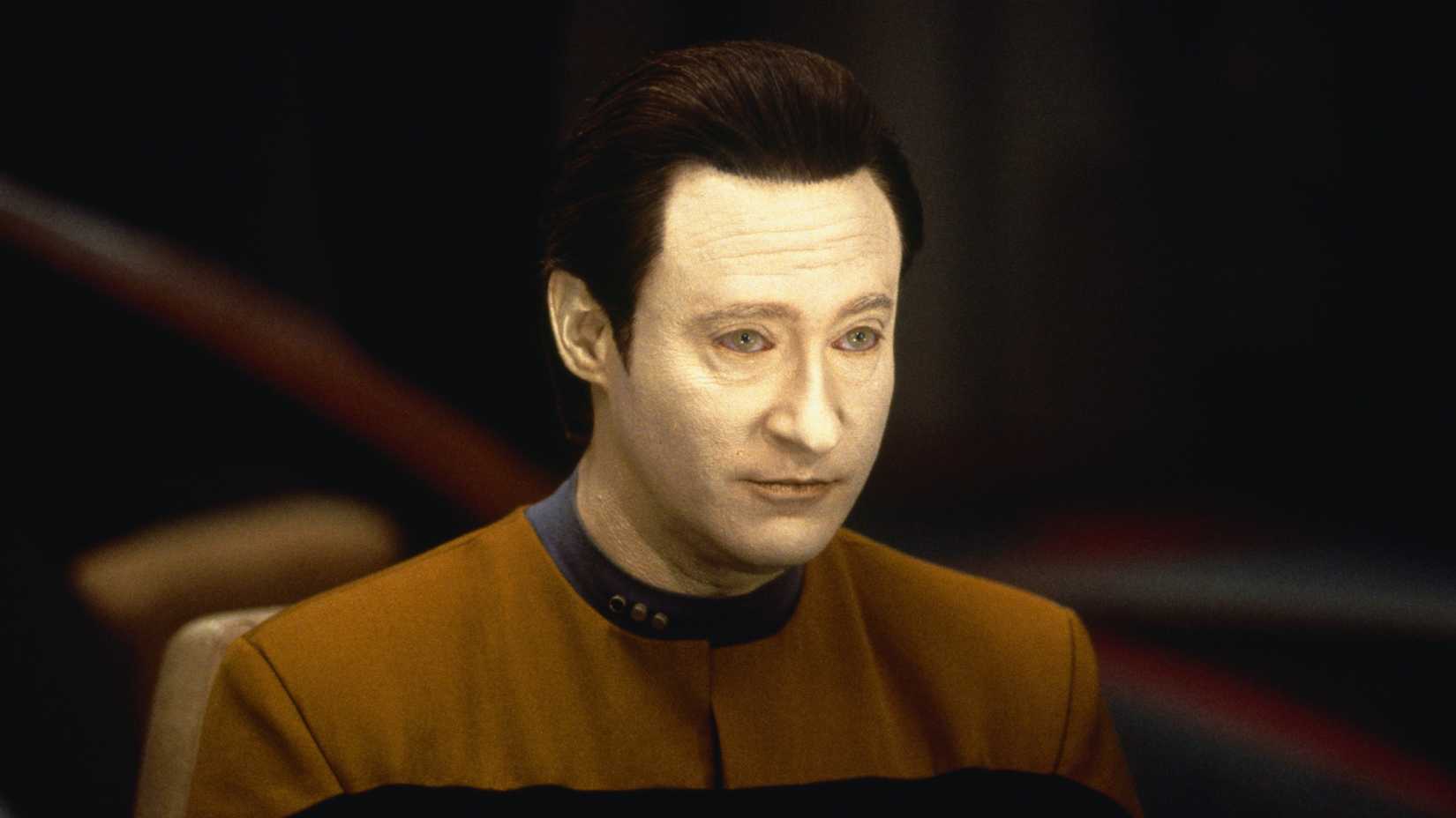 Data seated at his station on the Enterprise-D's bridge