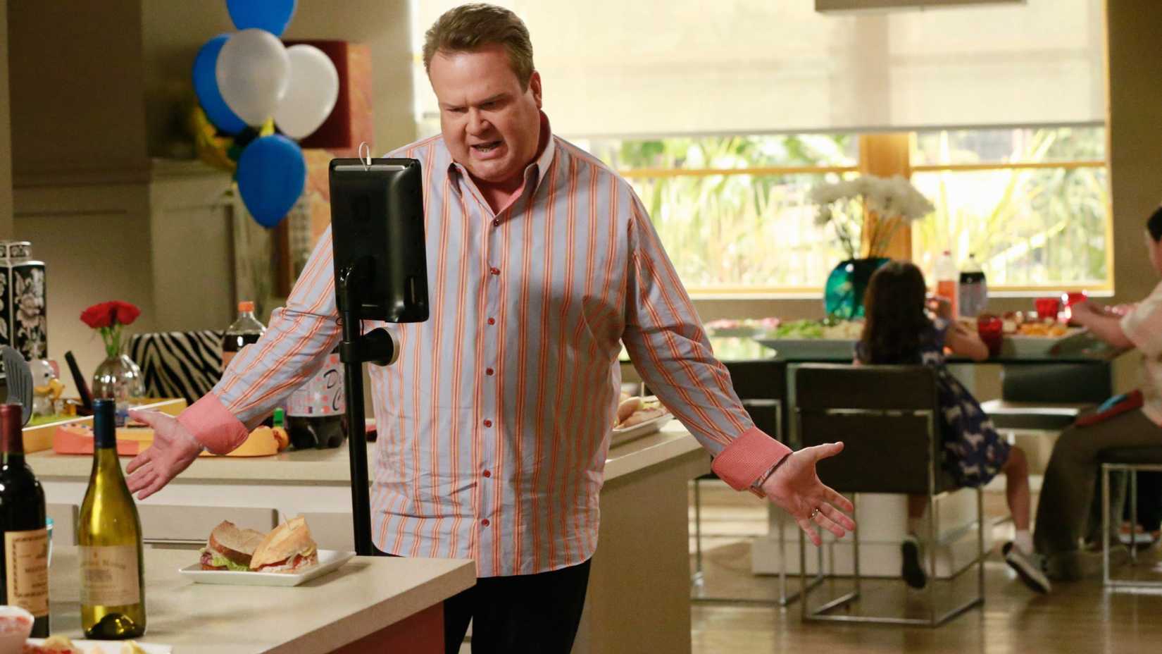 Cameron talking to a tablet in Modern Family season 6 episode 24