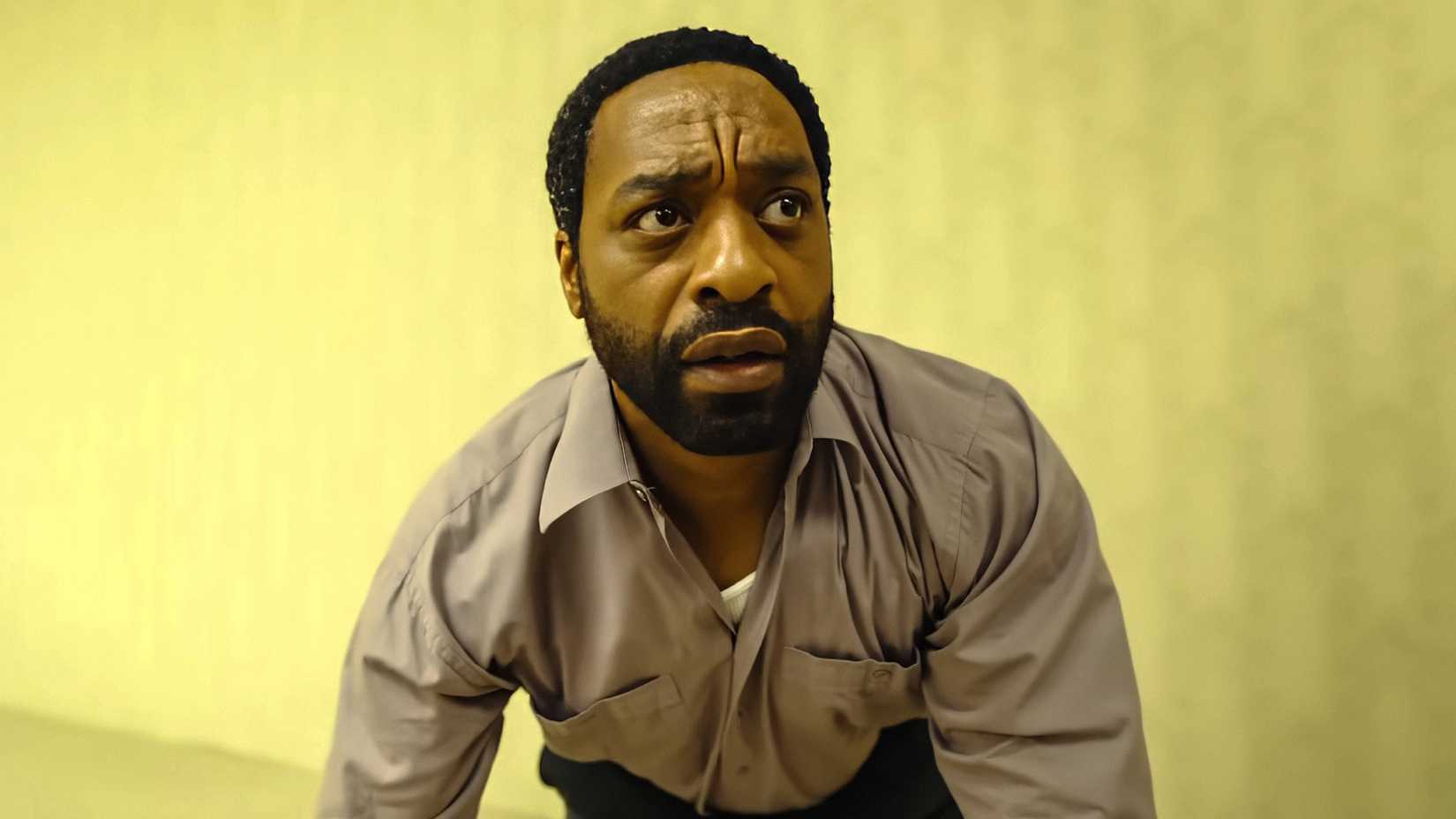 Chiwetel Ejiofor's Clark looking confused while kneeling on the ground in Backrooms