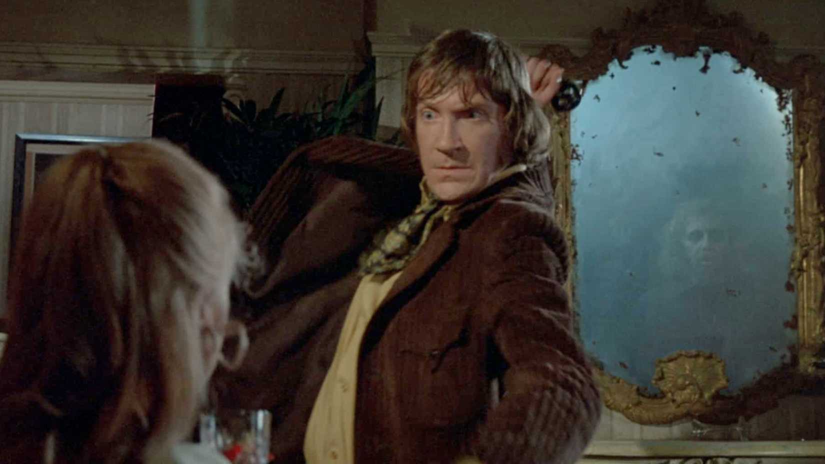 David Warner lunging at a woman in From Beyond the Grave (1974)