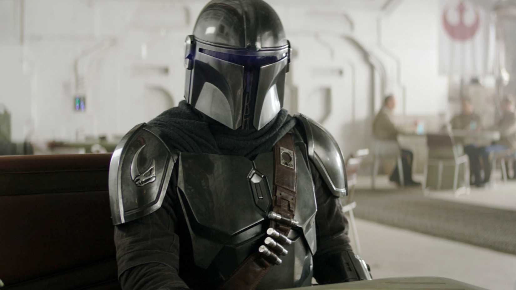 Din Djarin sitting at a table in The Mandalorian and Grogu
