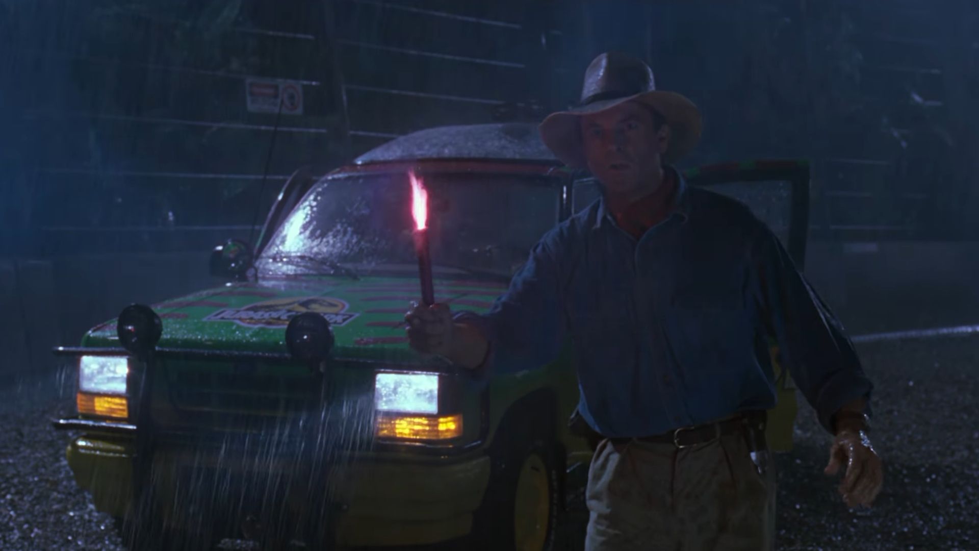 Dr Grant (Sam Neill) holding a flare as the t rex escapes in Jurassic Park
