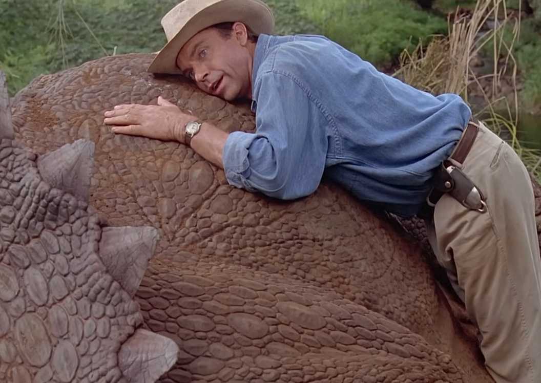 Dr Grant (Sam Neill) listening to a triceratops breathing in Jurassic Park