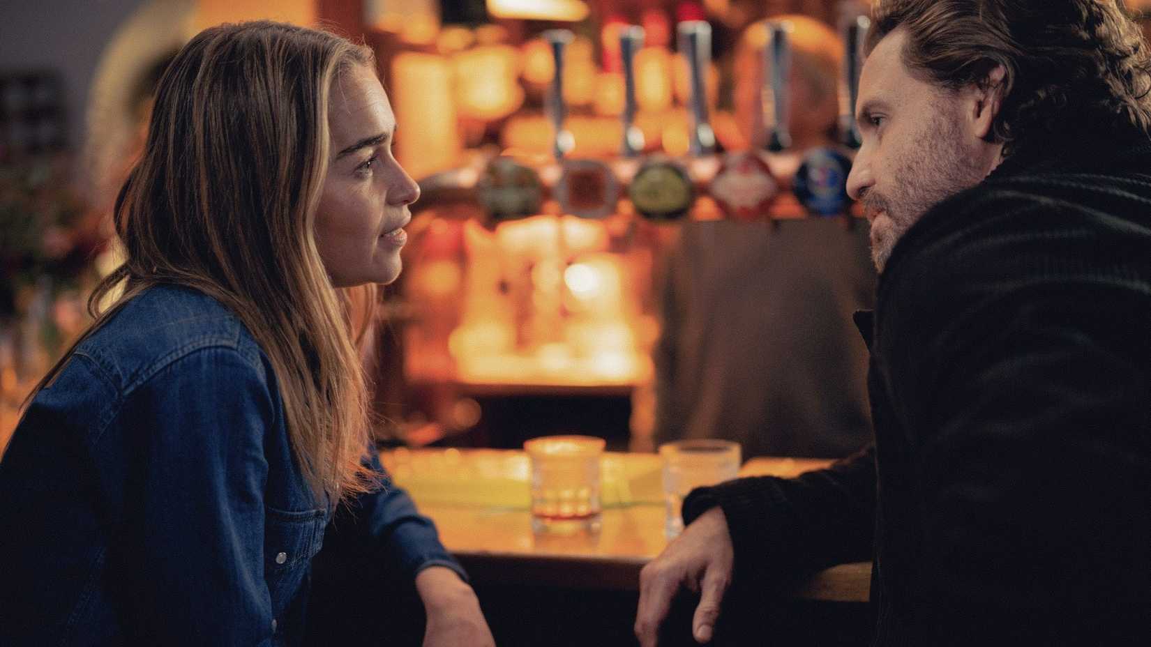 Emilia Clarke and Edgar Ramirez looking at each other in Next Life