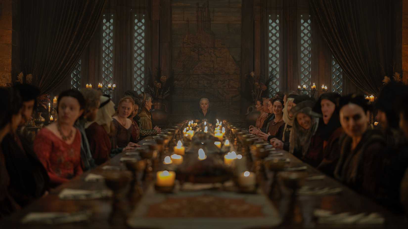 Rhaenyra sitting at a banquet table with King's Landing's lower nobles