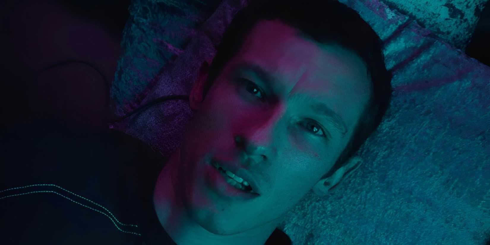 Callum Turner’s Case gazing up at the sky in Apple TV’s Neuromancer