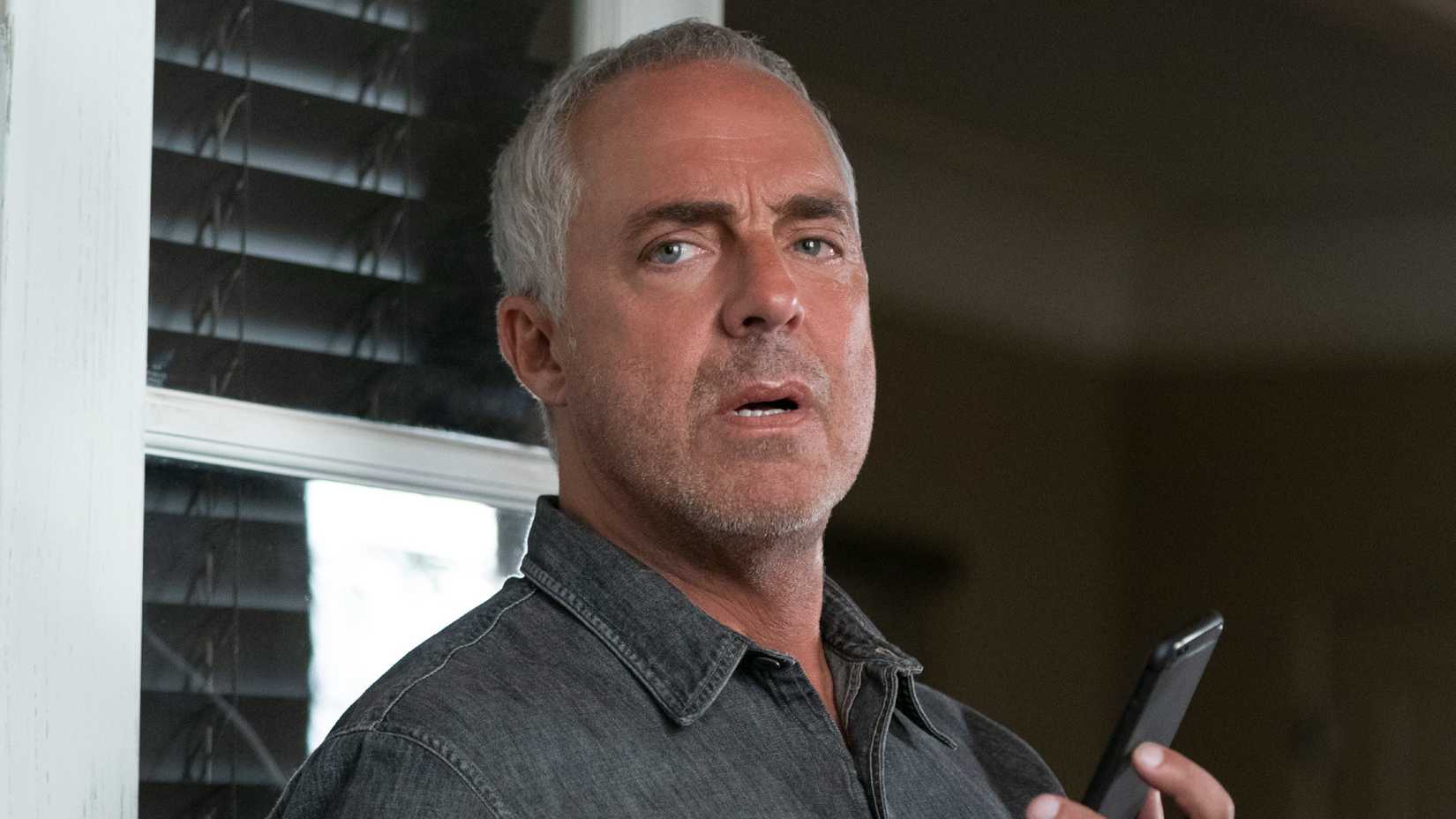 Titus Welliver’s Harry Bosch talking on the phone in Prime Video’s Bosch: Legacy