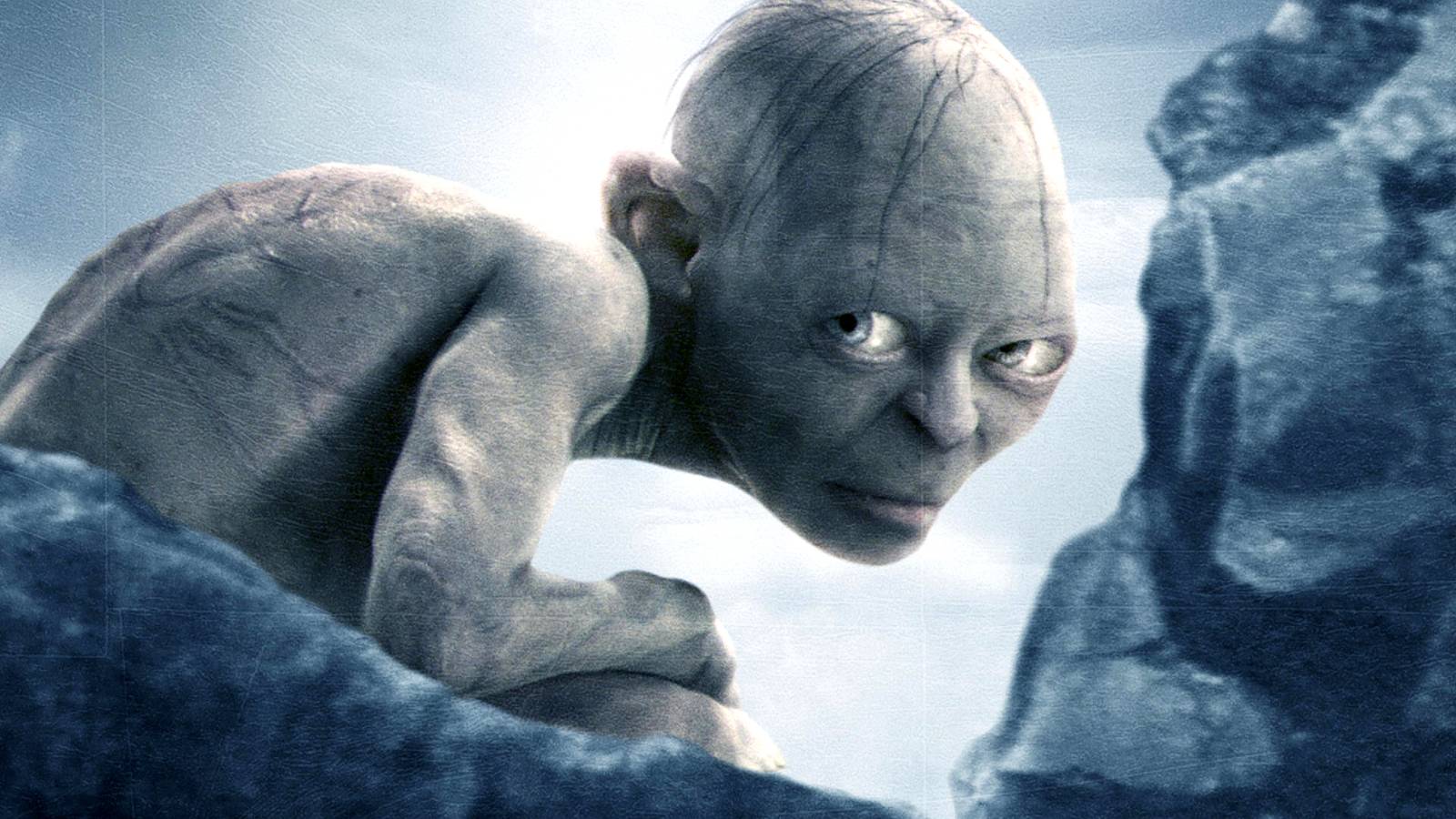 Gollum glaring from behind rocks in a promotional image for The Lord of the Rings The Return of the King