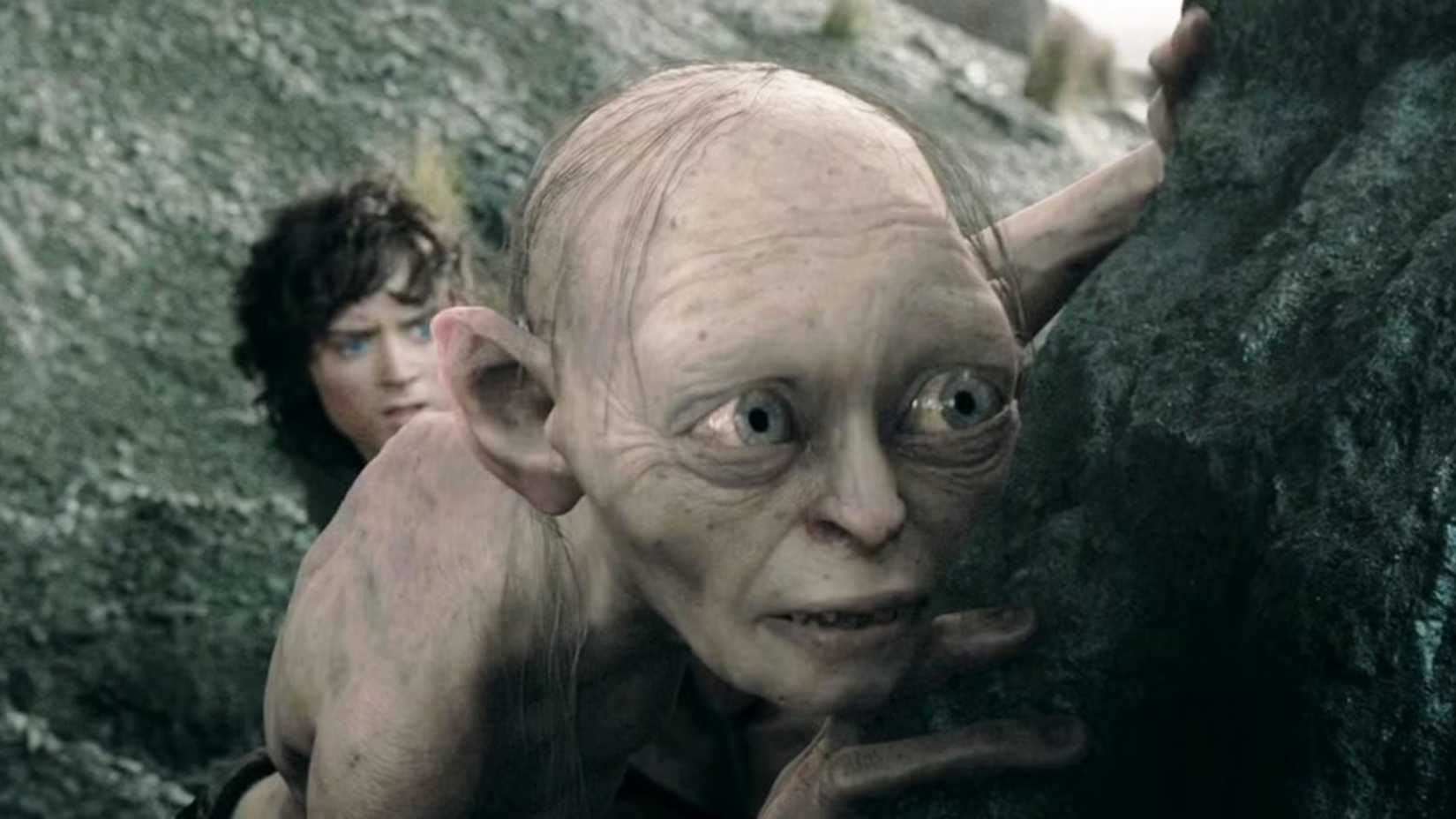 Gollum is hiding behind a rock in The Lord of the Rings The Two Towers