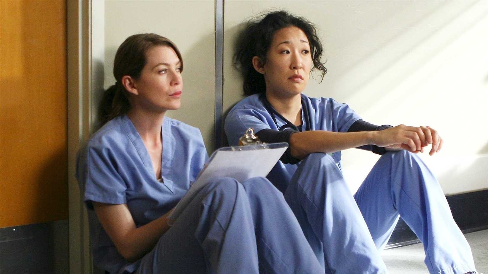 Sandra Oh as Cristina Yang and Ellen Pompeo as Meredith Grey in Grey's Anatomy.