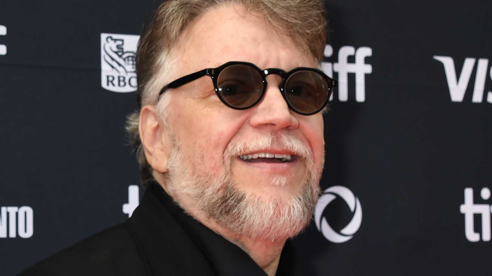 Guillermo del Toro wearing sunglasses on the red carpet at TIFF