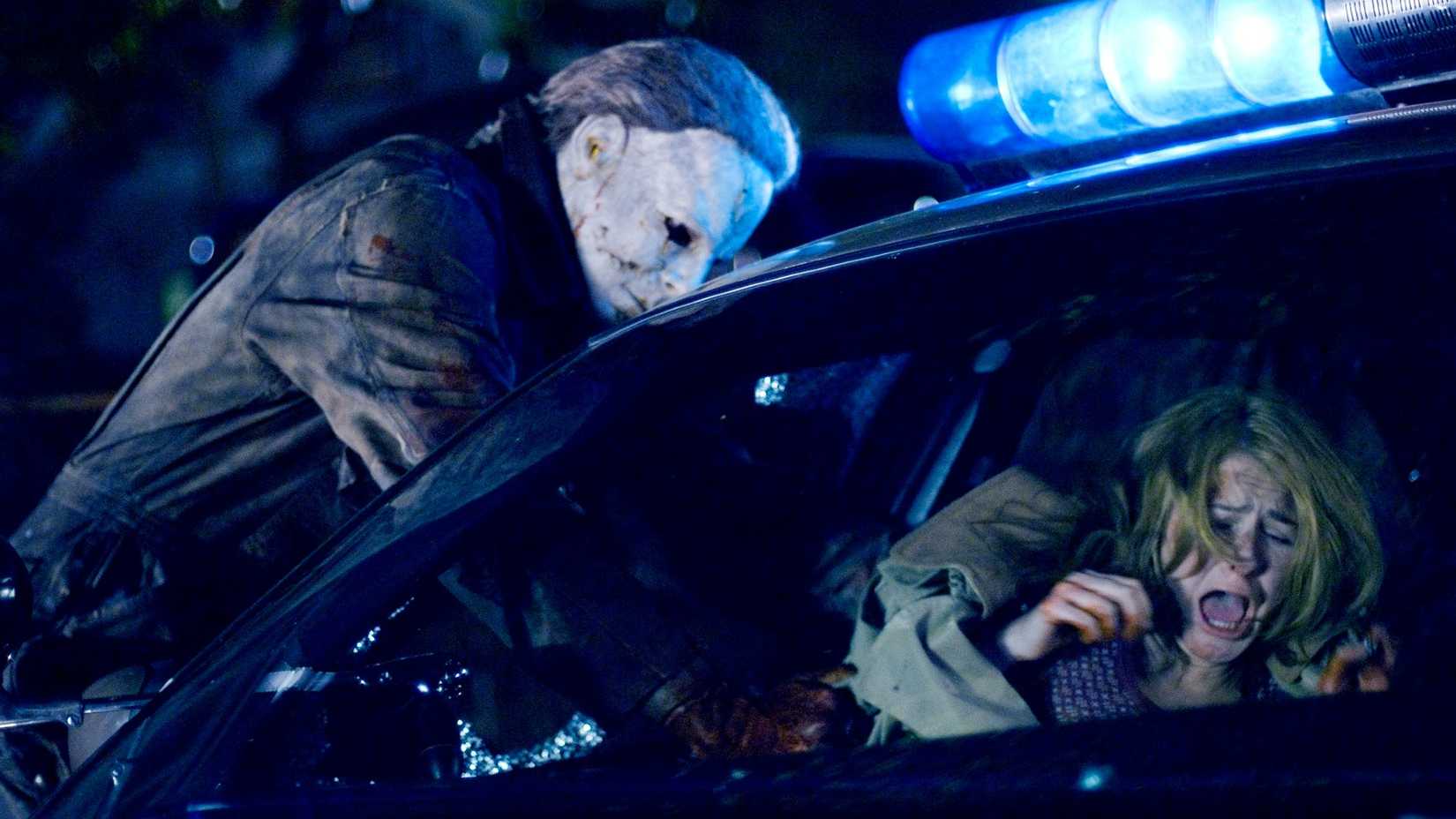 Michael Myers reaches into a cop car in Halloween 2007