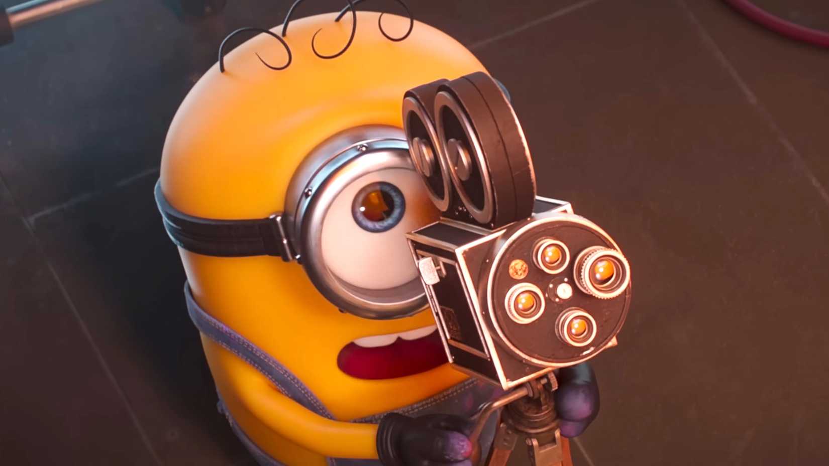 James looking up in shock while pointing a camera in Minions & Monsters