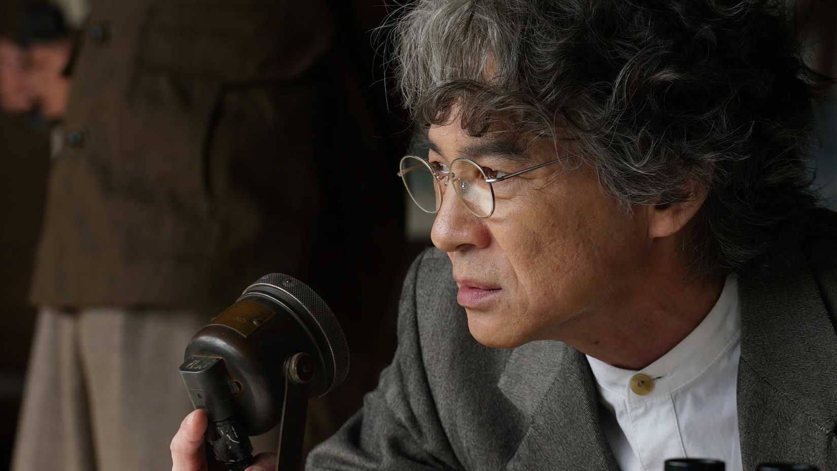 Japanese scientist looking closely outside in Godzilla Minus Zero