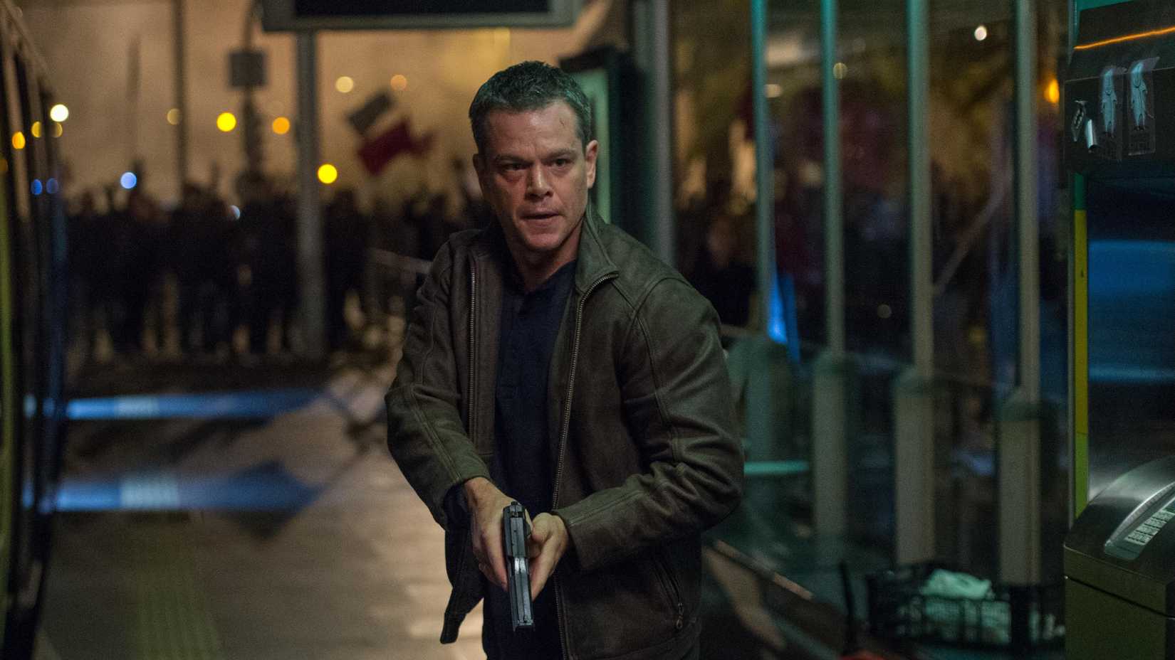 Matt Damon holds a pistol as Bourne in Jason Bourne
