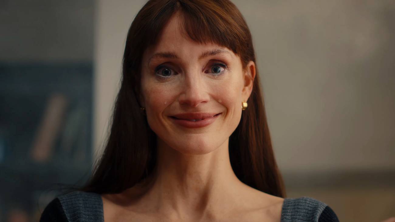 Jessica Chastain giving a tight-lipped smile as tears roll down her face in Other Mommy