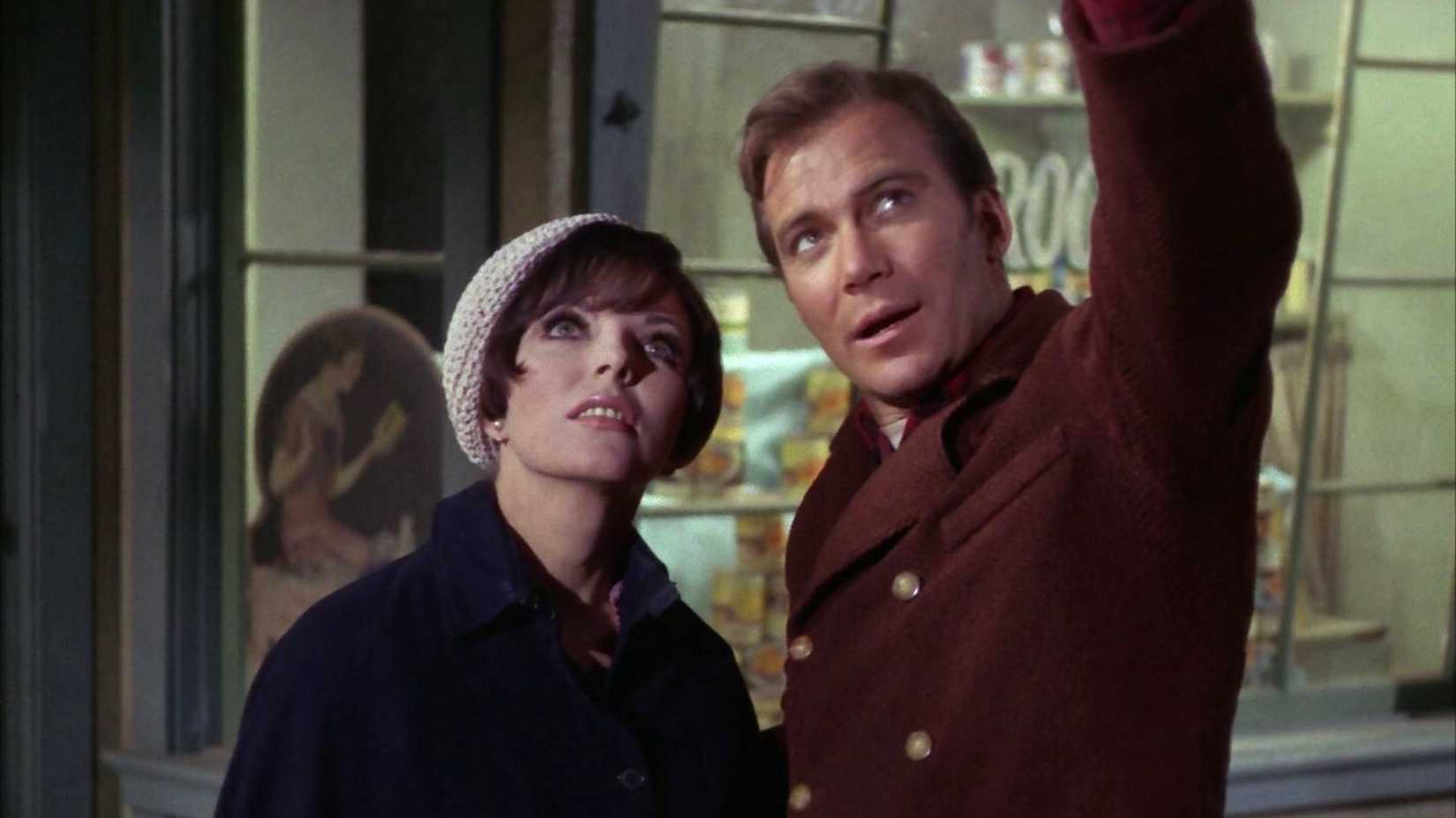 Joan Collins as Edith and WIlliam Shatner as Kirk pointing up in Star Trek