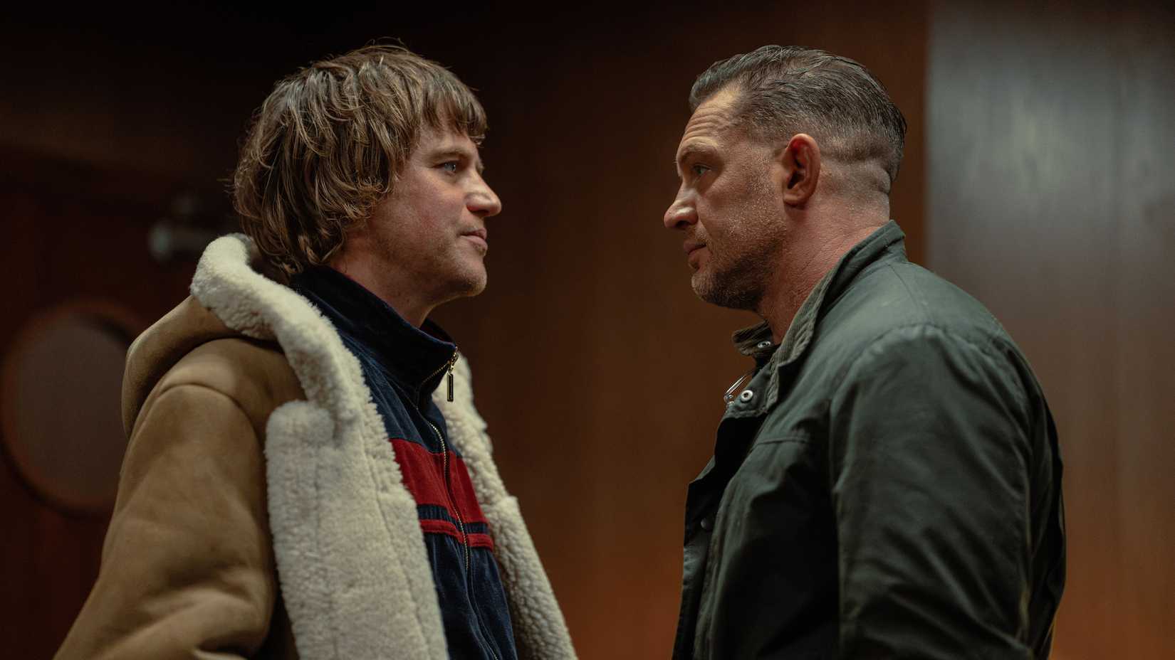 Tom Hardy and Johnny Flynn facing each other in a MobLand season 2 scene
