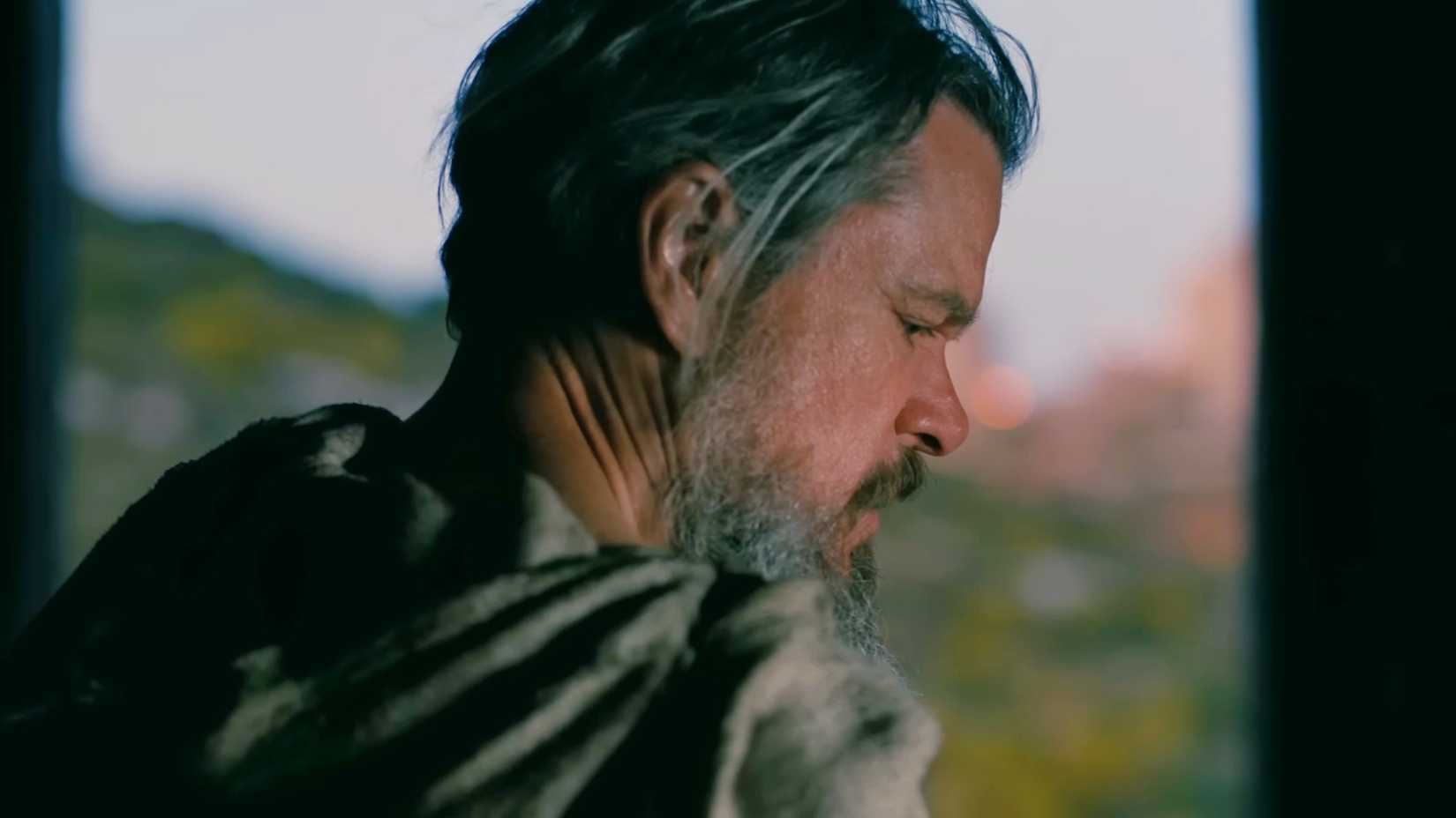 Matt Damon as Odysseus viewed in profile in a doorway in The Odyssey