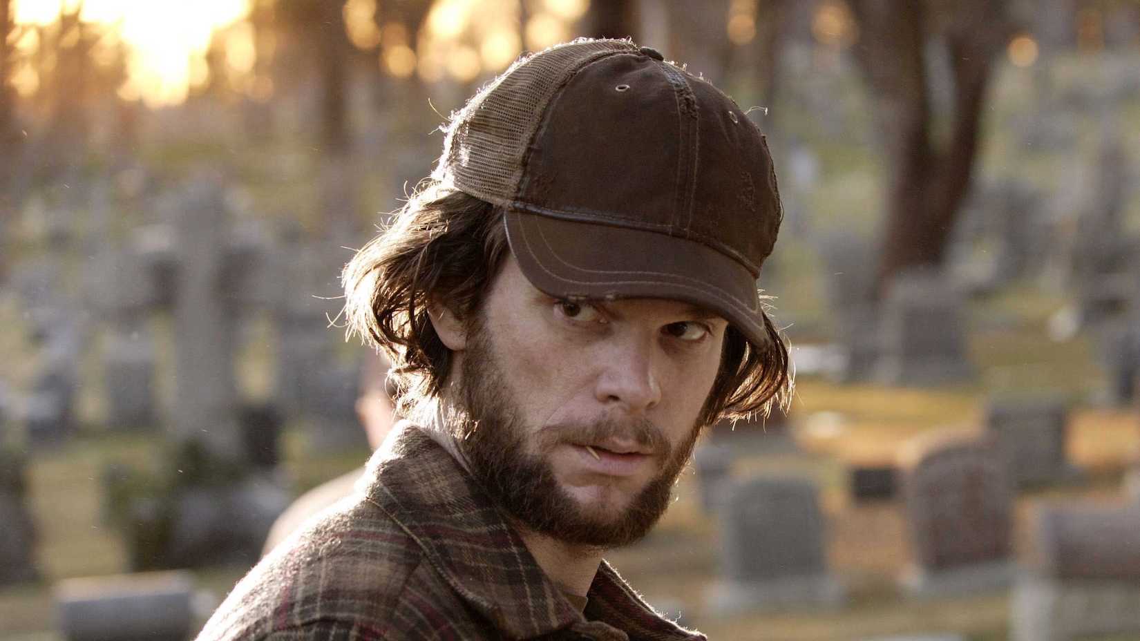 Ted Sprague in a graveyard looking back at something in Heroes season 1