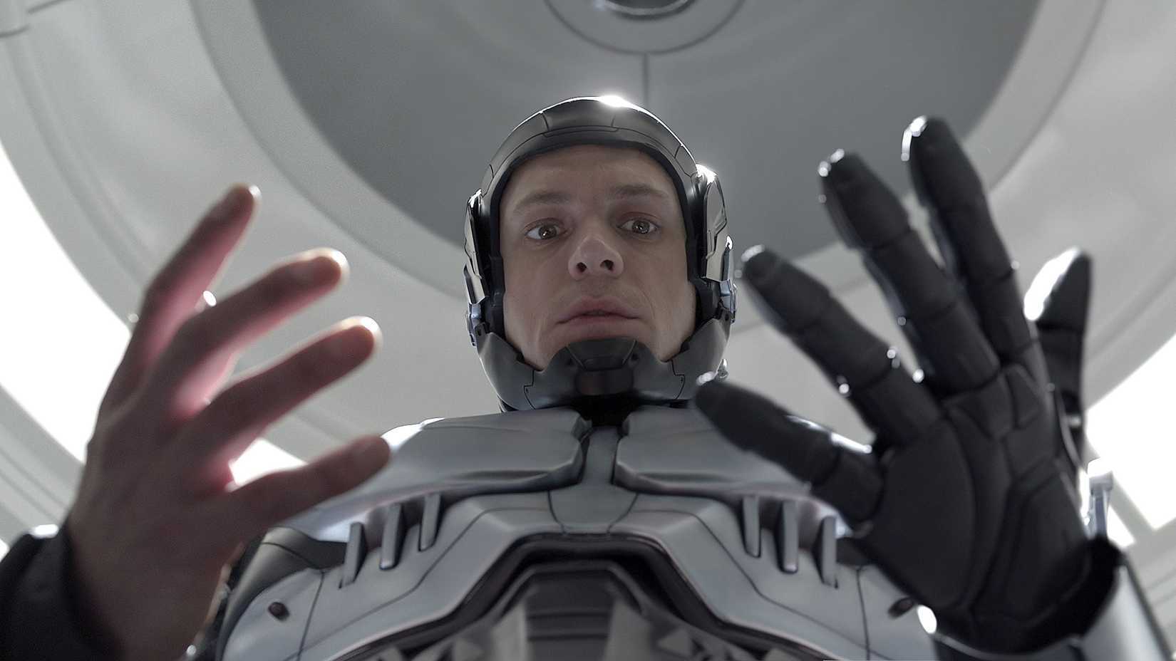Alex Murphy (Joel Kinnaman) looking at his new cybernetic body in RoboCop.