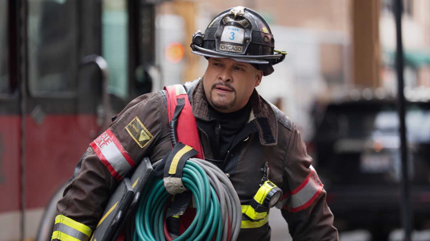 Joe Cruz carrying a hose in Chicago Fire season 14