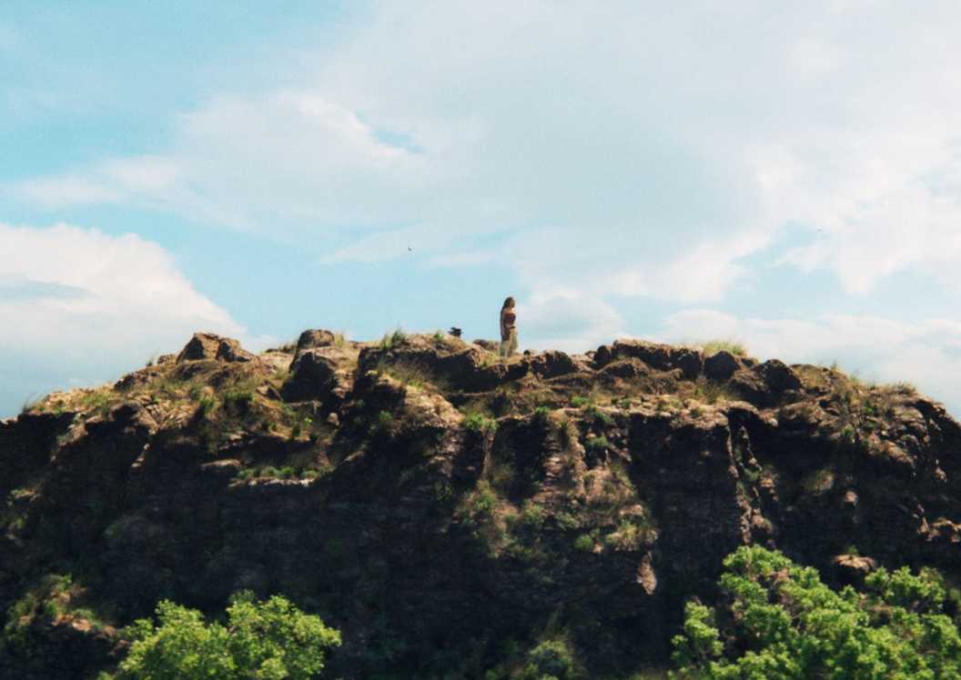 Moana stands atop a mountain in Moana 2026
