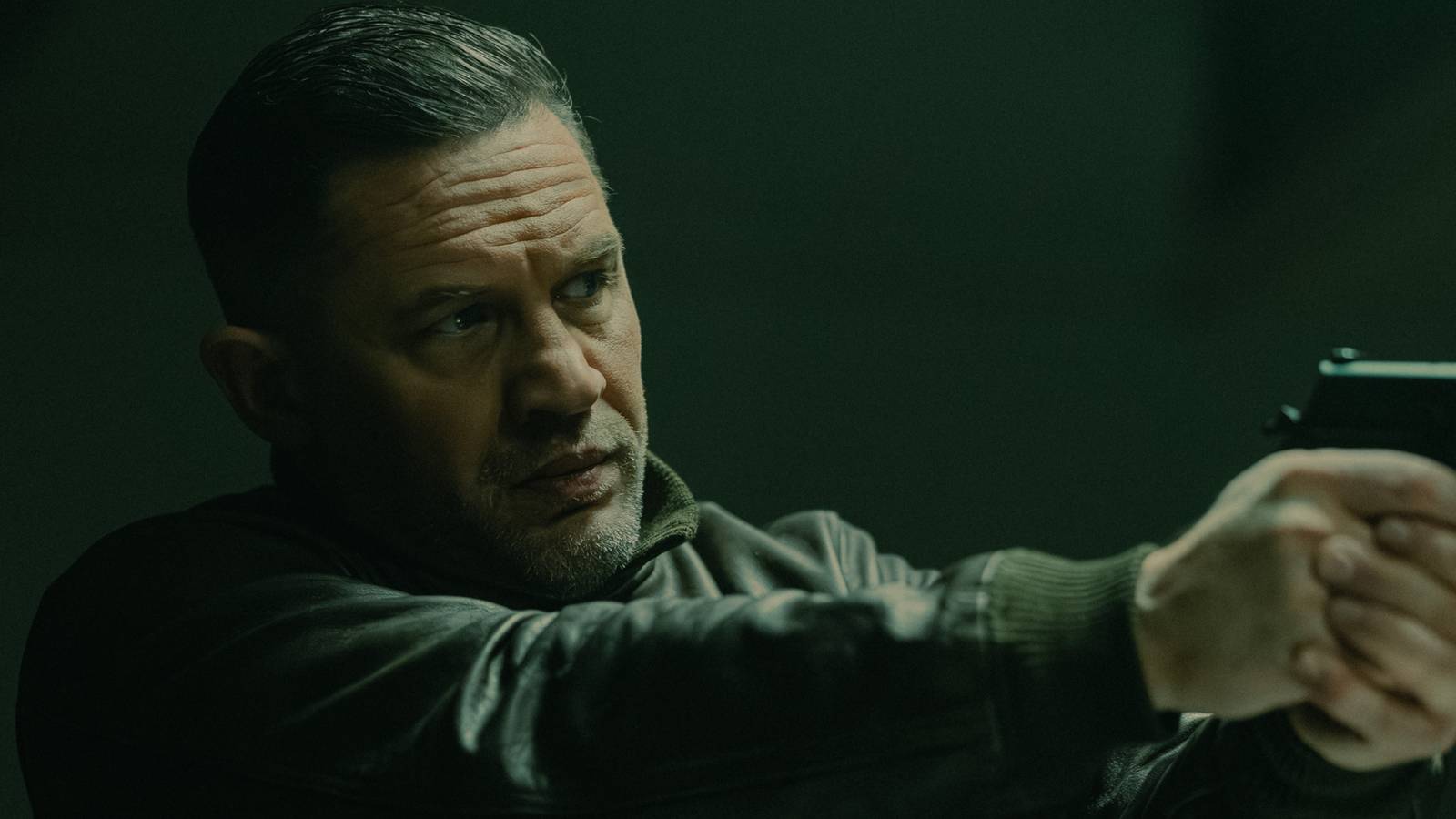 Tom Hardy as Harry Da Souza pointing a gun in MobLand