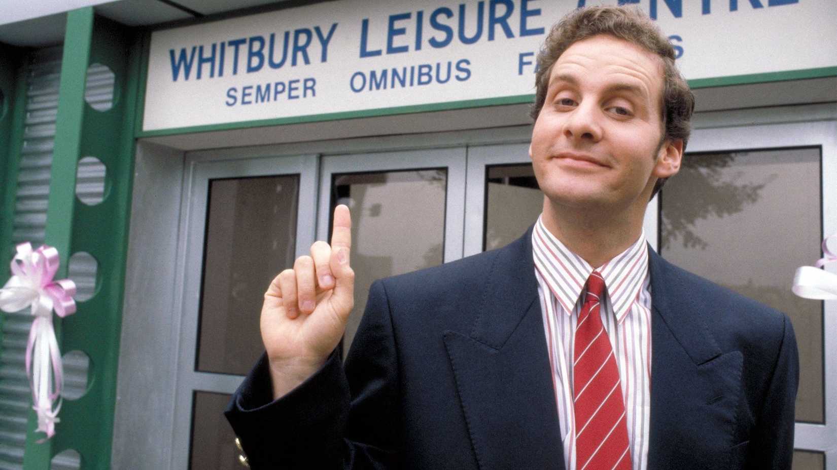 Mr Brittas pointing to a sign in The Brittas Empire