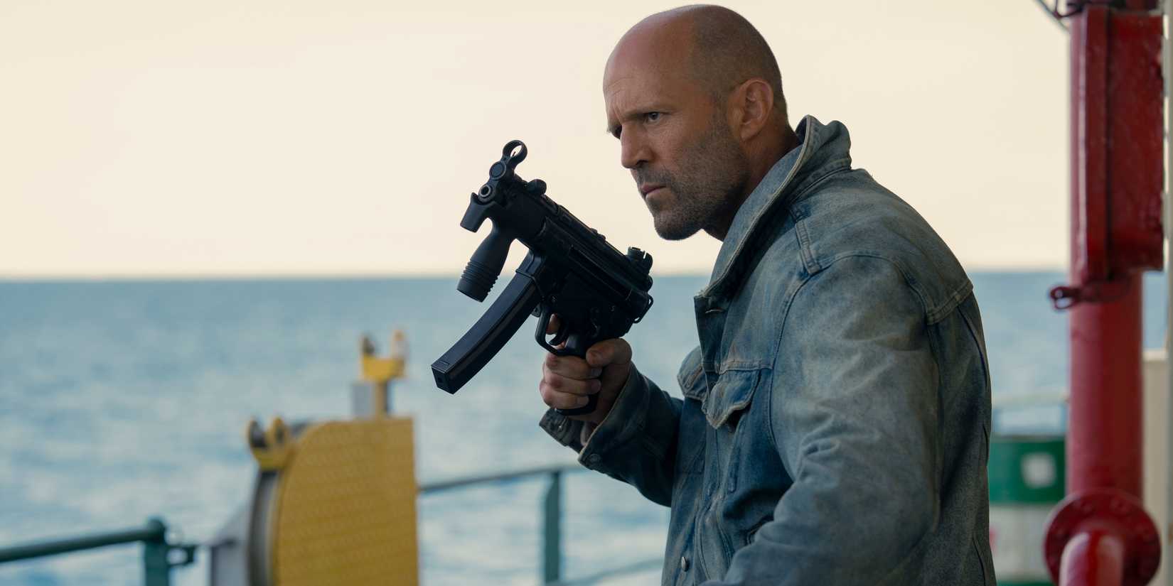 Jason Statham with a machine gun on a boat in Mutiny