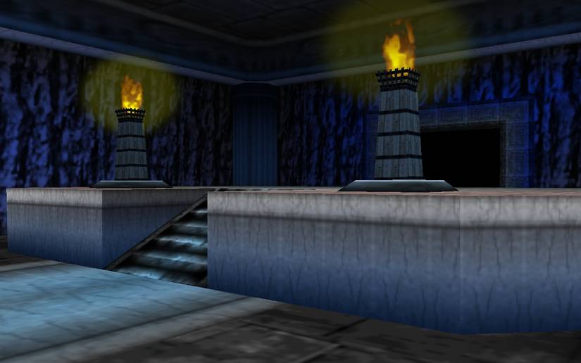 Two lit torches on a raised platform in the catacombs below Kakariko graveyard.