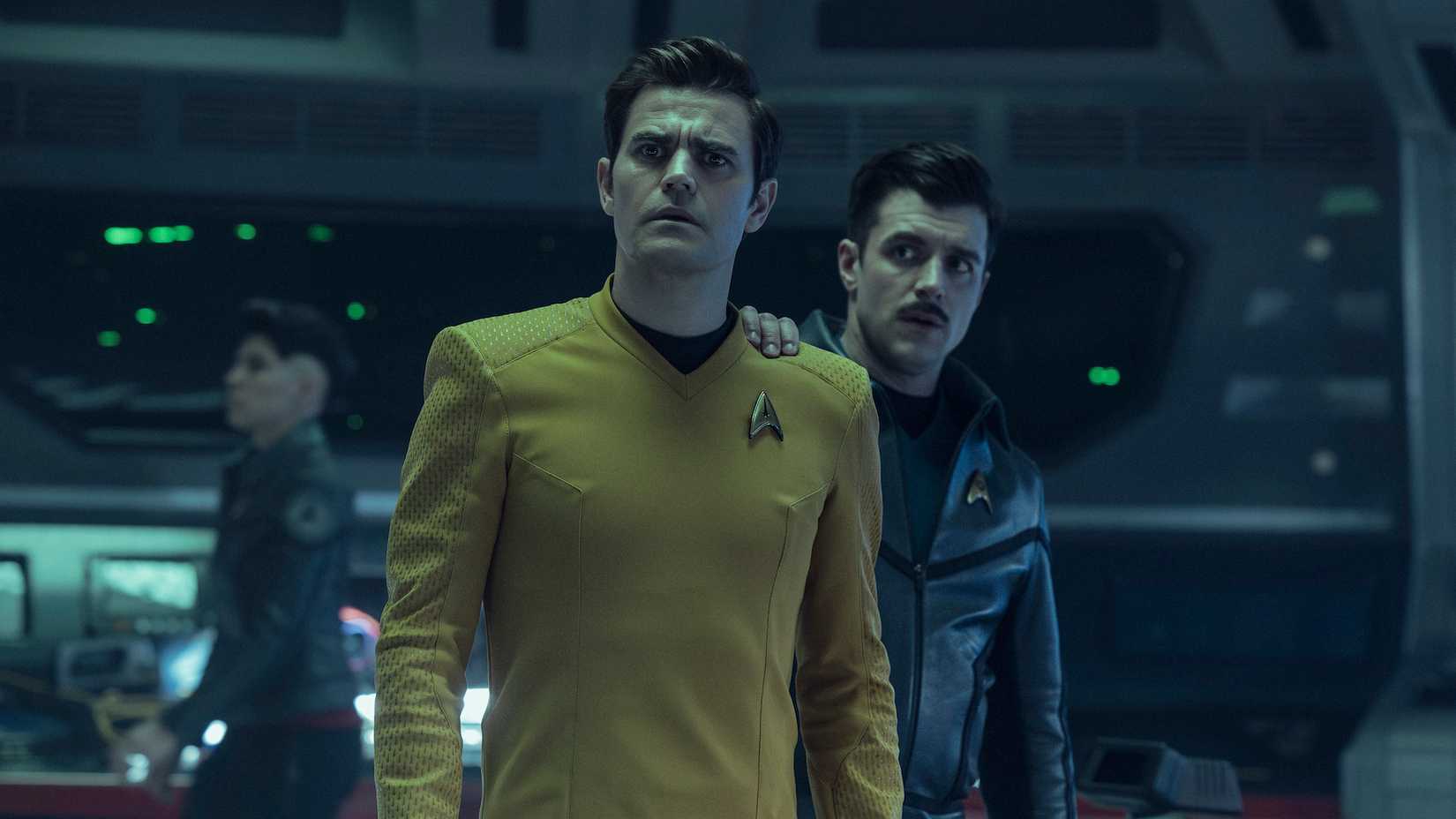 Jim and Sam Kirk standing together on the darkened USS Enterprise bridge