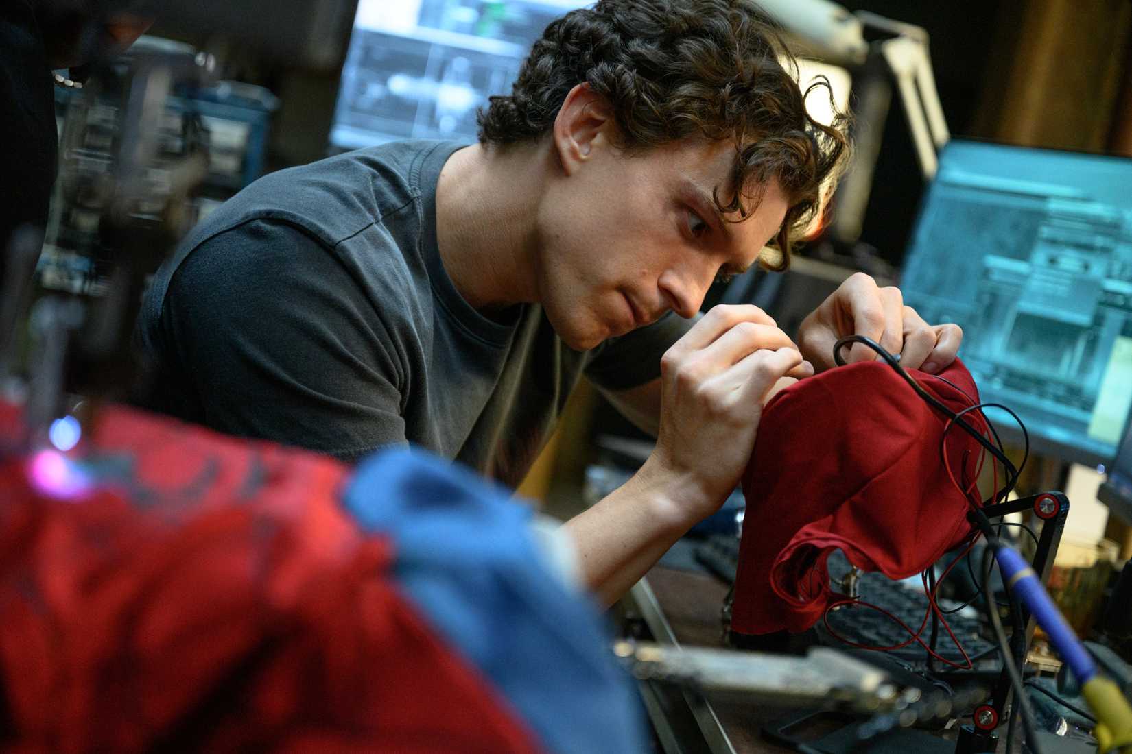 Peter Parker (Tom Holland) works on his suit in SPIDER-MAN BRAND NEW DAY