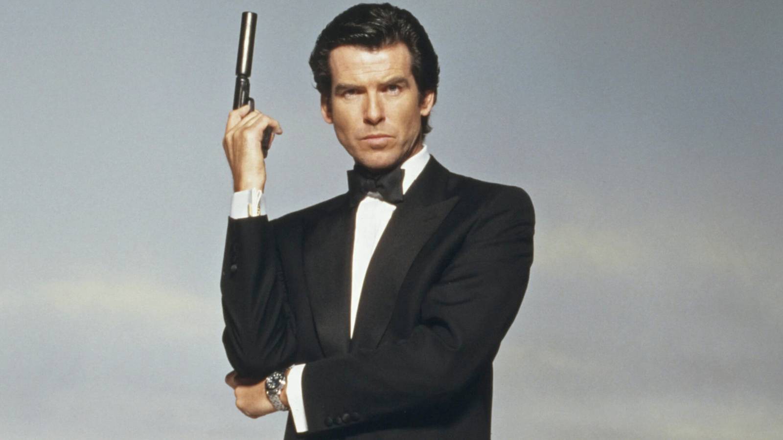 Pierce Brosnan's James Bond in Tuxedo posing with Walther PPK
