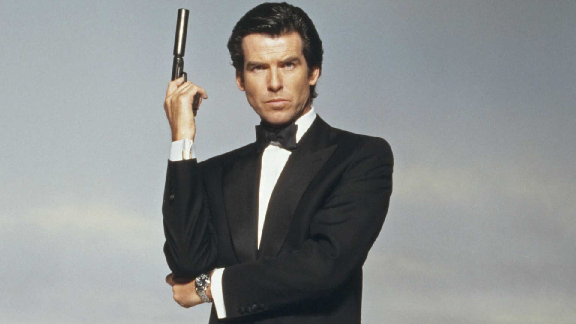 Pierce Brosnan's James Bond in Tuxedo posing with Walther PPK