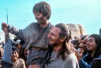 Qui-Gon Jinn holding up a young Anakin Skywalker in Star Wars Episode I - The Phantom Menace