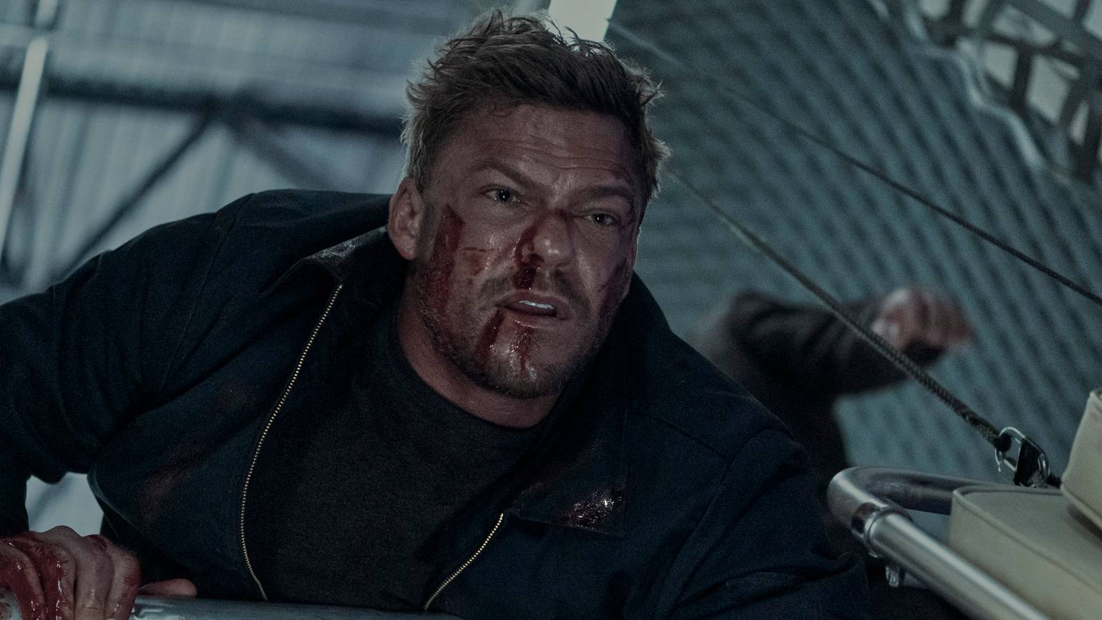 Alan Ritchson with a bloody face in Reacher